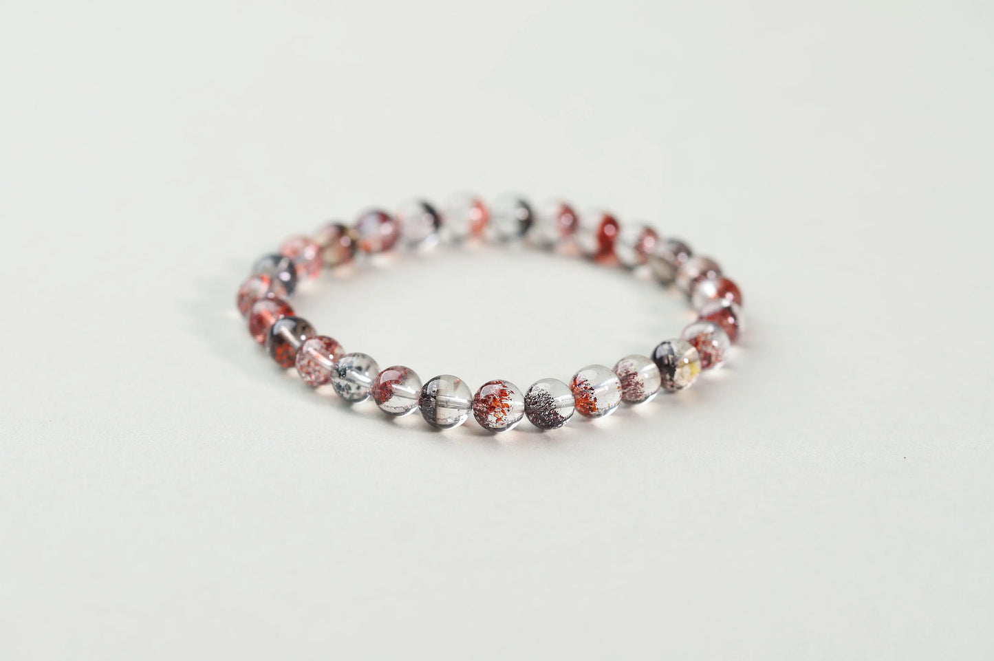 Red Inclusion Quartz Bracelet | Clear Crystal with Fiery Sparks for Vitality, Passion & Grounded Action | Root Chakra Gift BuddhaCrystal